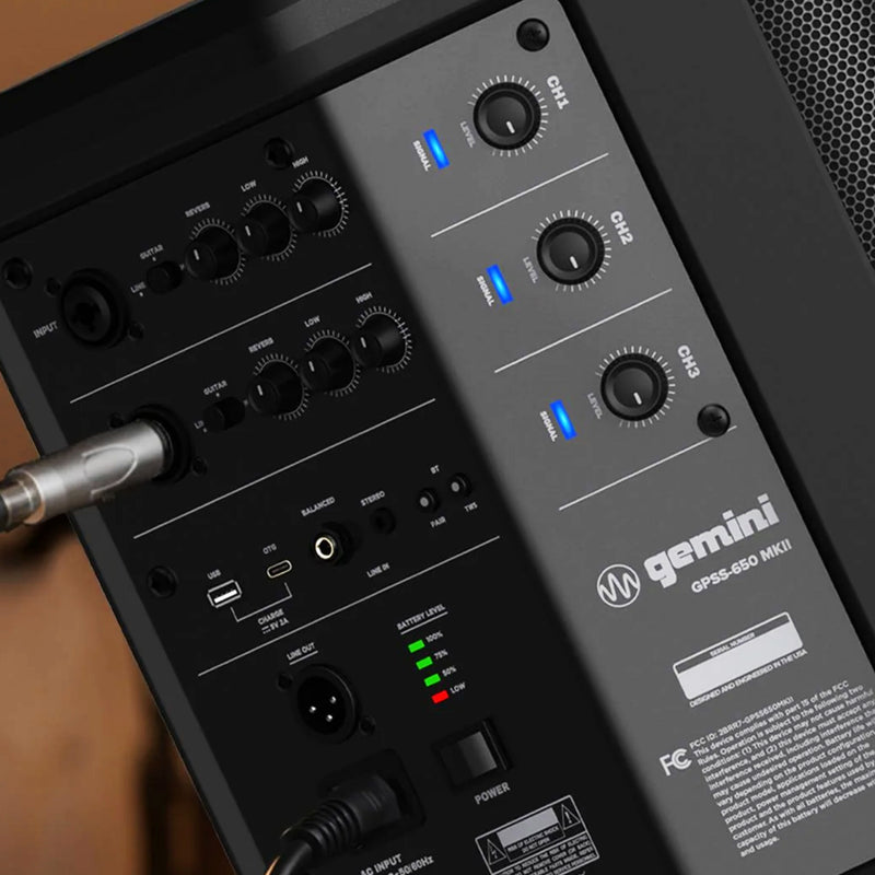 Close-up of the rear panel of a Gemini GPS-450 MKII speaker amplifier, showing multiple black control knobs, input/output jacks, LED indicator lights, and branding on a dark gray panel.